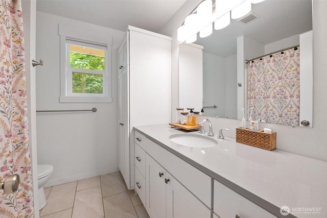 full bath featuring vanity, toilet, and tile patterned floors