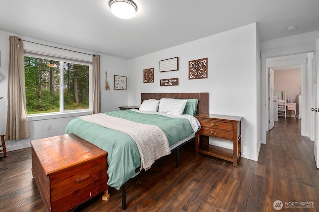 bedroom with wood finished floors and baseboards