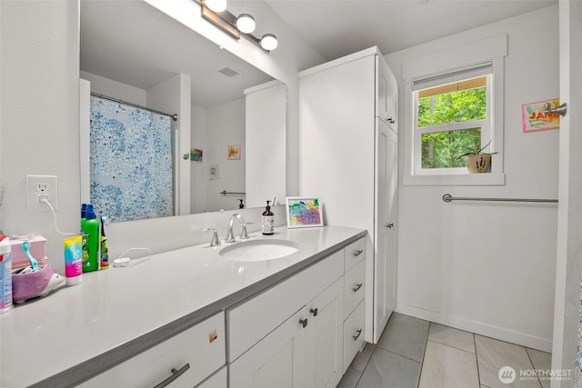 bathroom featuring tile patterned flooring and vanity