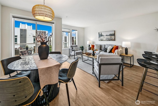 2432 Dexter Ave N Unit 201, Seattle, WA 98109 - dining space with light wood-style floors and baseboards