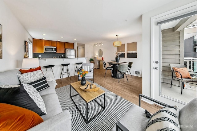 2432 Dexter Ave N Unit 201, Seattle, WA 98109 - living room with light wood-type flooring, recessed lighting, and baseboards