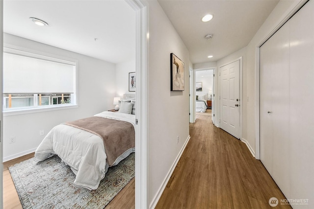 2432 Dexter Ave N Unit 201, Seattle, WA 98109 - bedroom featuring wood finished floors, baseboards, recessed lighting, and a closet