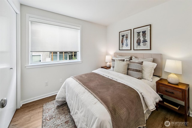 2432 Dexter Ave N Unit 201, Seattle, WA 98109 - bedroom with wood finished floors, baseboards, and a closet