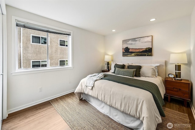 2432 Dexter Ave N Unit 201, Seattle, WA 98109 - bedroom with wood finished floors, baseboards, and recessed lighting