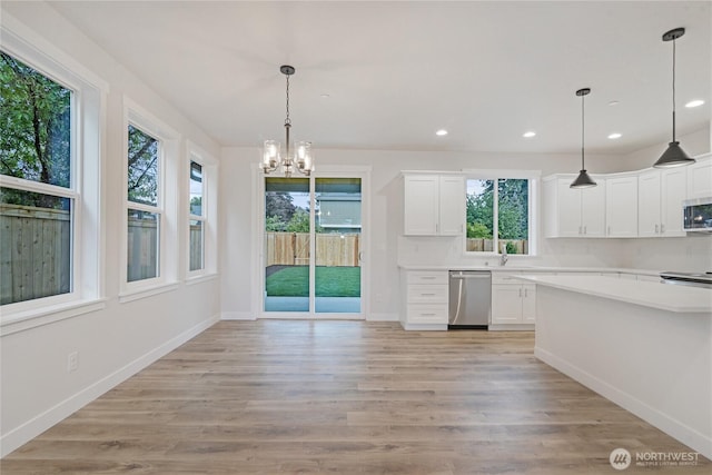 kitchen with stainless steel appliances, a chandelier, light countertops, white cabinetry, and recessed lighting