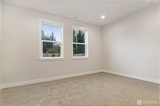 empty room with carpet floors, baseboards, and recessed lighting