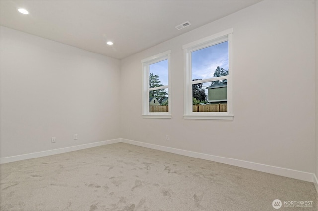 spare room with baseboards, light colored carpet, and recessed lighting