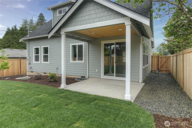 back of house with roof with shingles, a patio, and crawl space