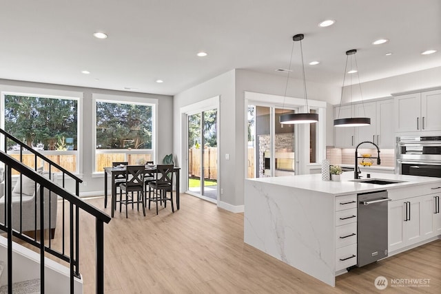 1428 238th St SE, Bothell, WA 98021 - kitchen with a sink, backsplash, appliances with stainless steel finishes, light wood-style floors, and recessed lighting