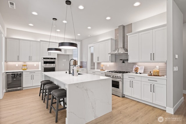 1428 238th St SE, Bothell, WA 98021 - kitchen with wine cooler, stainless steel appliances, a sink, wall chimney range hood, and tasteful backsplash