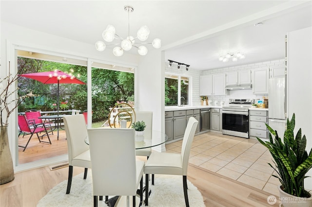 dining room with a chandelier and light wood-style flooring