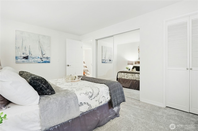 bedroom with carpet floors and two closets