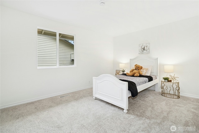 bedroom with carpet and baseboards