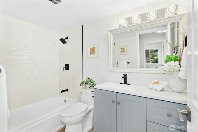 full bathroom featuring vanity, bathtub / shower combination, and toilet