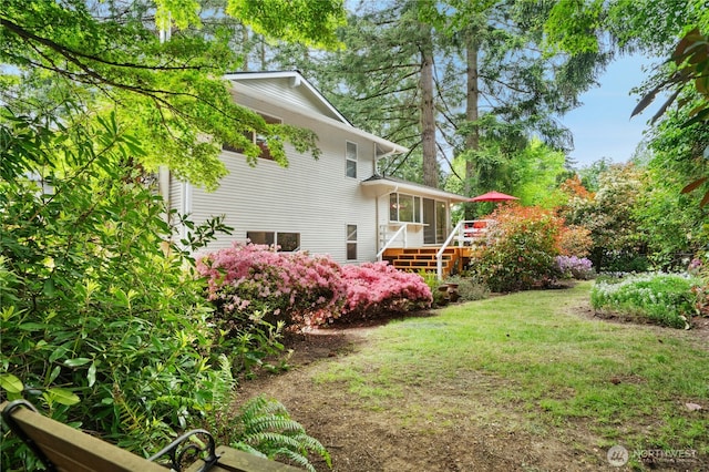 view of grassy yard featuring a wooden deck