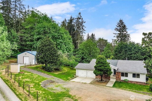 view of front of house with driveway, a garage, and a front yard