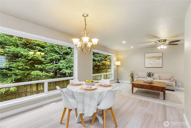dining room featuring a chandelier, baseboards, light wood finished floors, and recessed lighting