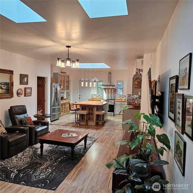 5830 115th Pl NE, Kirkland, WA 98033 - living area featuring a skylight, light wood-type flooring, and a chandelier