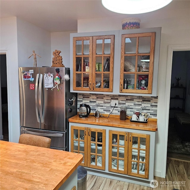 5830 115th Pl NE, Kirkland, WA 98033 - kitchen featuring freestanding refrigerator, wood counters, glass insert cabinets, backsplash, and wood finished floors