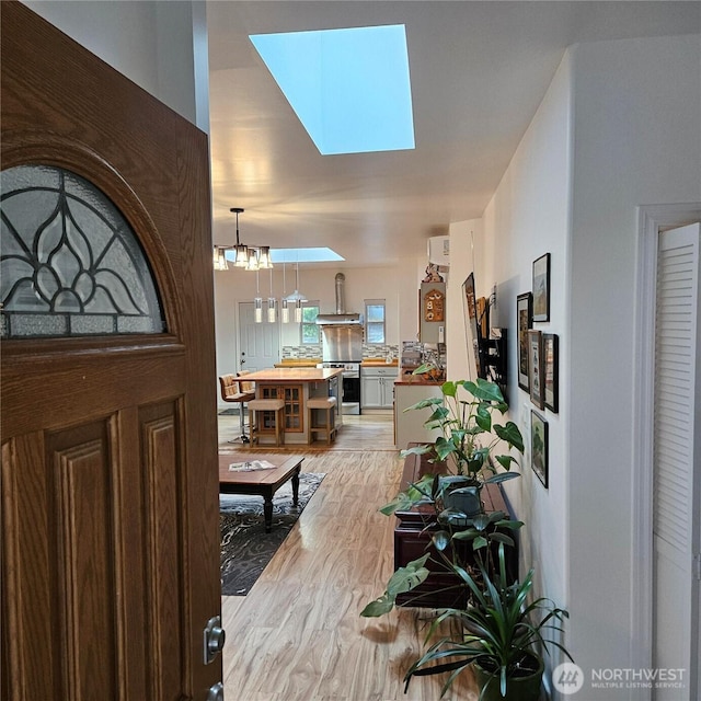 5830 115th Pl NE, Kirkland, WA 98033 - foyer entrance with a skylight, light wood-style floors, and a chandelier