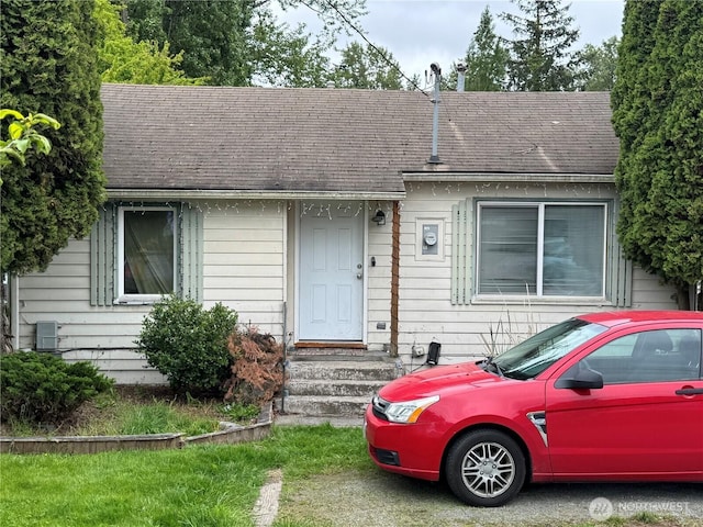 view of front of house with a shingled roof