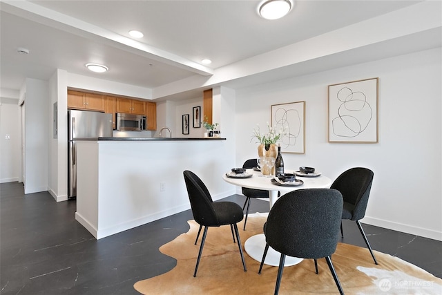 dining area featuring baseboards and recessed lighting