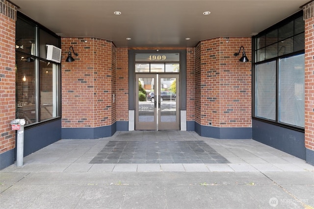 property entrance with french doors and brick siding