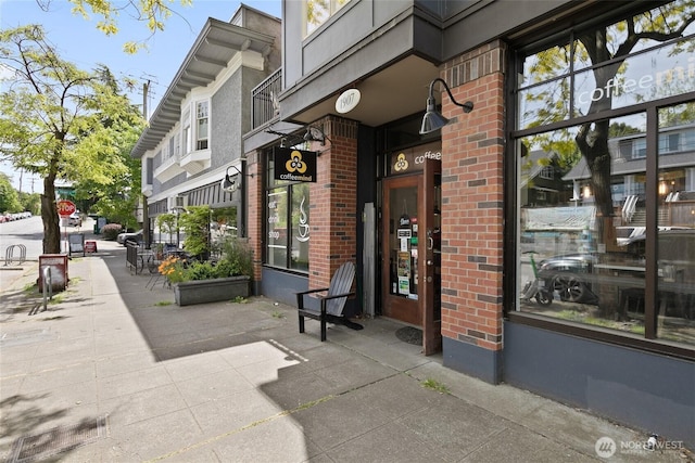 view of exterior entry featuring brick siding