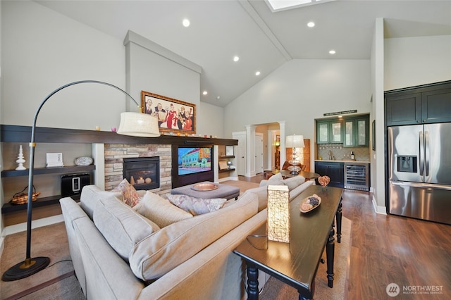 371 Reserve Way, Walla Walla, WA 99362 - living area featuring wine cooler, a stone fireplace, bar area, dark wood-style floors, and high vaulted ceiling