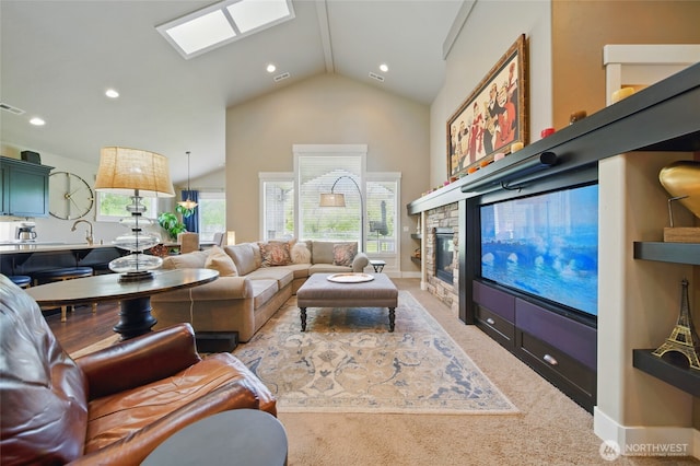371 Reserve Way, Walla Walla, WA 99362 - living room with vaulted ceiling, a skylight, a stone fireplace, recessed lighting, and carpet