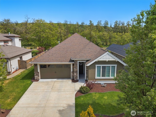 371 Reserve Way, Walla Walla, WA 99362 - view of front of house featuring concrete driveway, an attached garage, stone siding, and a view of trees
