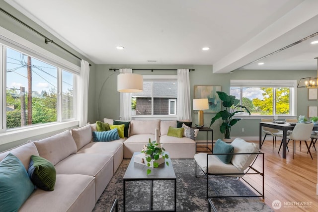 living room with wood finished floors, baseboards, recessed lighting, and a chandelier