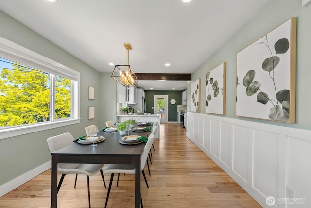 dining space with light wood finished floors and recessed lighting