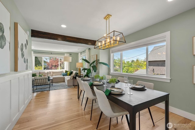 dining room featuring recessed lighting, light wood-type flooring, beamed ceiling, a chandelier, and baseboards