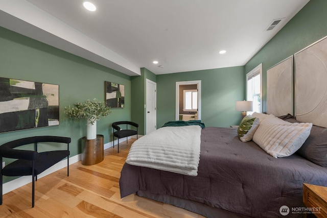 bedroom with wood finished floors and recessed lighting