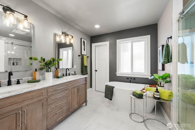 bathroom featuring a shower stall, marble finish floors, double vanity, a freestanding bath, and recessed lighting