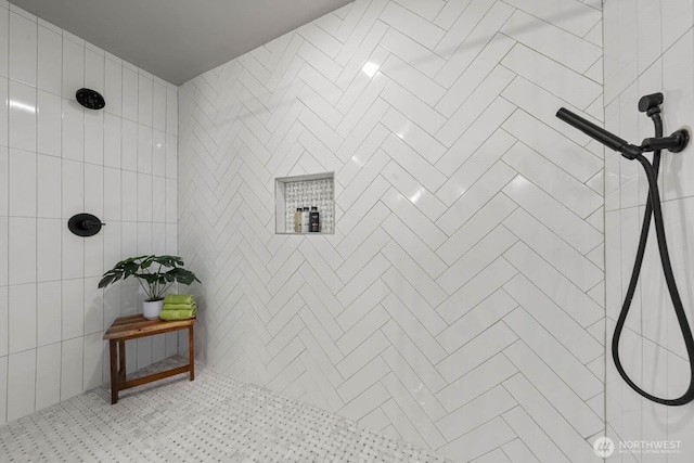 full bath featuring a tile shower