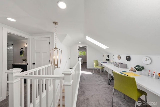 additional living space featuring a skylight, carpet, and vaulted ceiling
