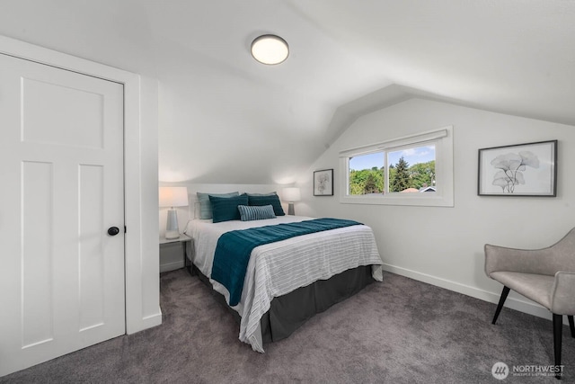 carpeted bedroom featuring vaulted ceiling and baseboards