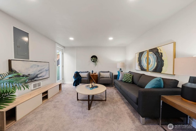 living area featuring carpet floors, electric panel, and recessed lighting