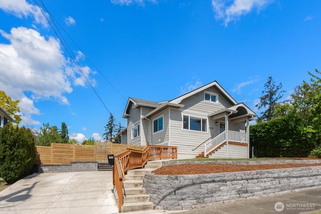 view of front of house featuring fence and stairs