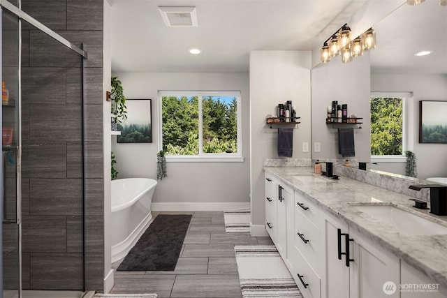 12915 212th St SE, Snohomish, WA 98296 - full bath featuring baseboards, a soaking tub, double vanity, a shower stall, and recessed lighting