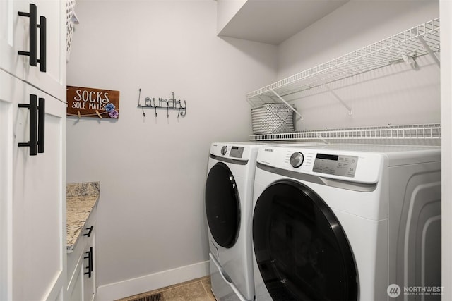 12915 212th St SE, Snohomish, WA 98296 - washroom featuring washer and clothes dryer, baseboards, and cabinet space