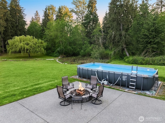 12915 212th St SE, Snohomish, WA 98296 - patio terrace at dusk featuring a yard, an outdoor pool, and an outdoor fire pit