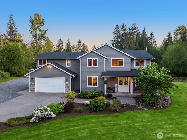 12915 212th St SE, Snohomish, WA 98296 - traditional-style house with driveway, a porch, a lawn, a garage, and stone siding