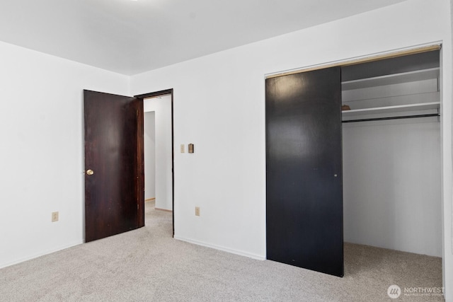 unfurnished bedroom with carpet flooring and a closet