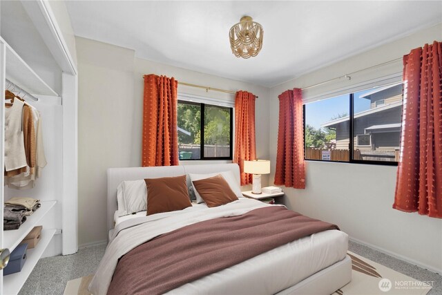 carpeted bedroom featuring baseboards