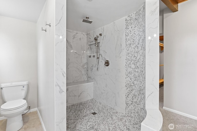 bathroom featuring a marble finish shower, toilet, and baseboards