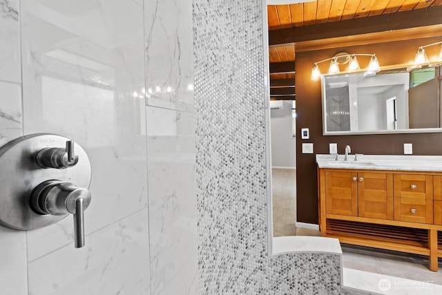 bathroom featuring a walk in shower and vanity