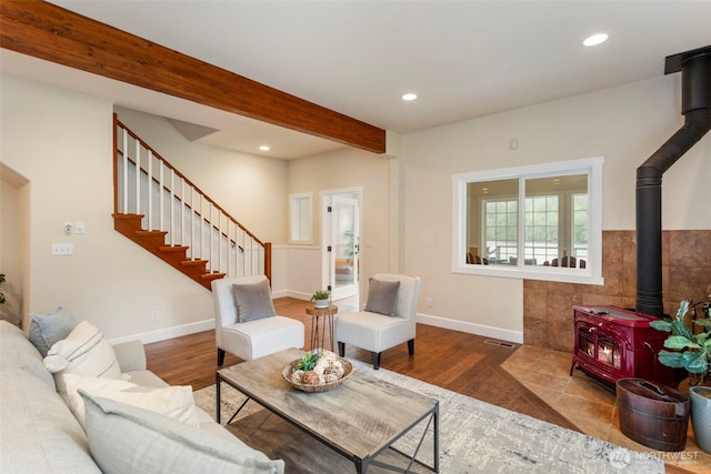 893 Snow Creek Rd, Quilcene, WA 98376 - living room featuring a wood stove, wood finished floors, recessed lighting, stairway, and beam ceiling
